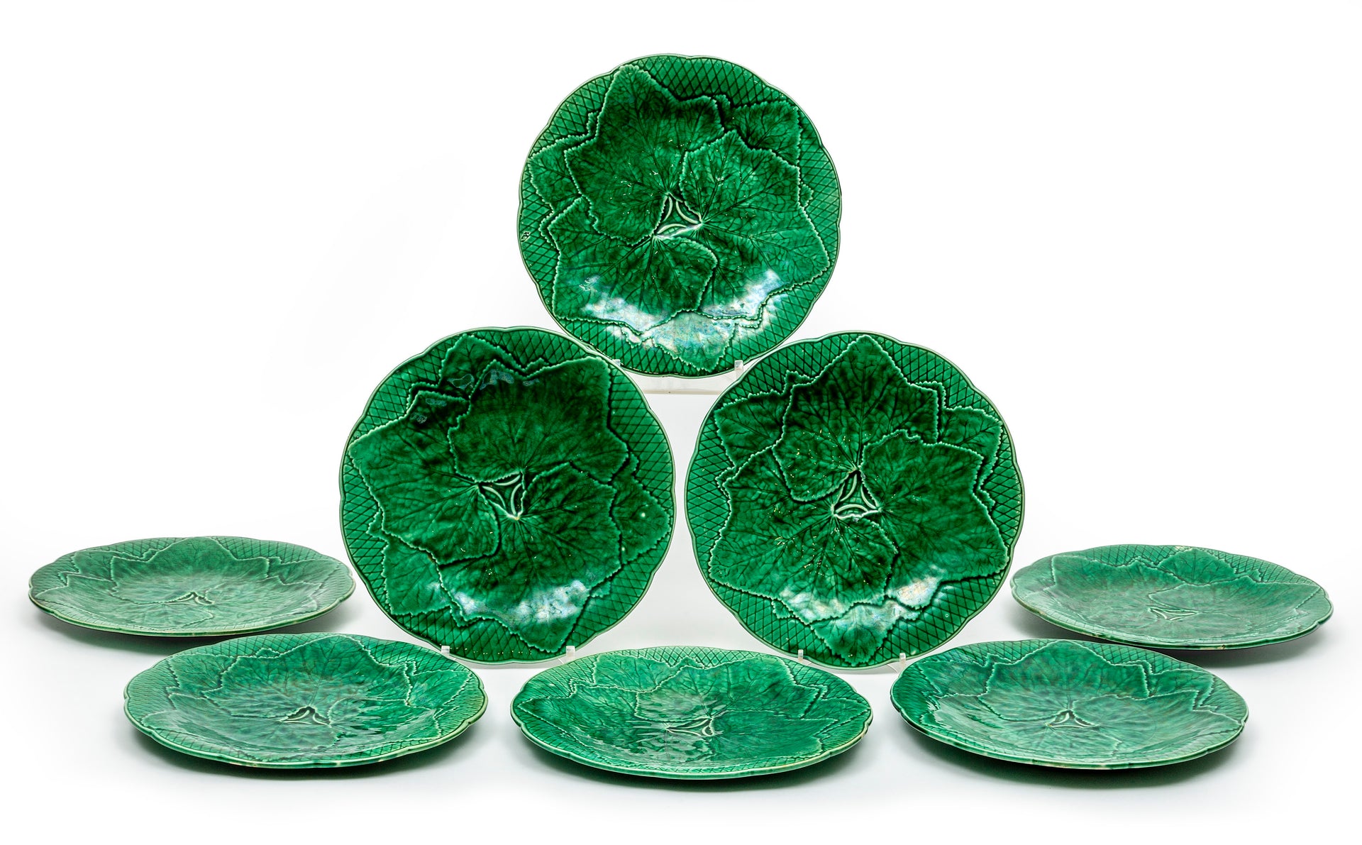 A set of eight green faience vine-leaf plates by GIEN, French Circa 1900