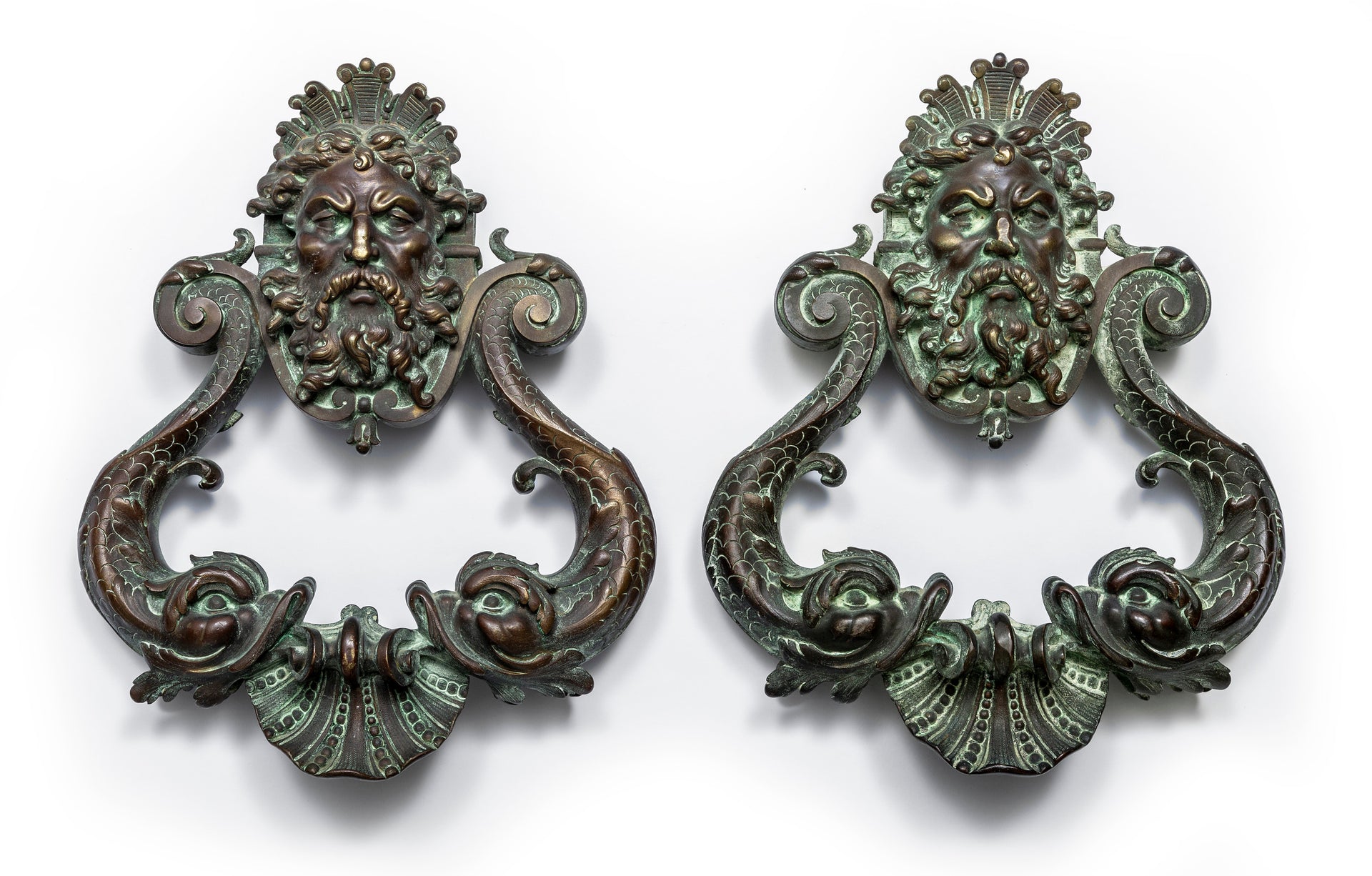 An exceptional pair of bronze door knockers, cast with the head of Neptune and twin dolphins French 19th Century