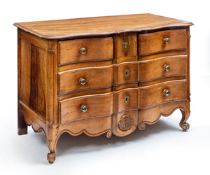 A lovely Provincial fruitwood serpentine four-drawer commode, French 18th Century