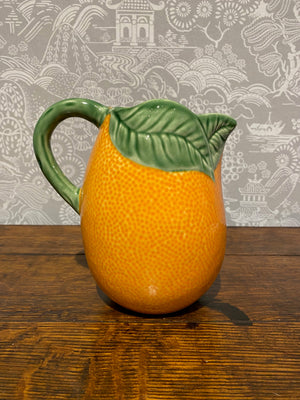 An orange pitcher by Bordallo Pinheiro, Portugal